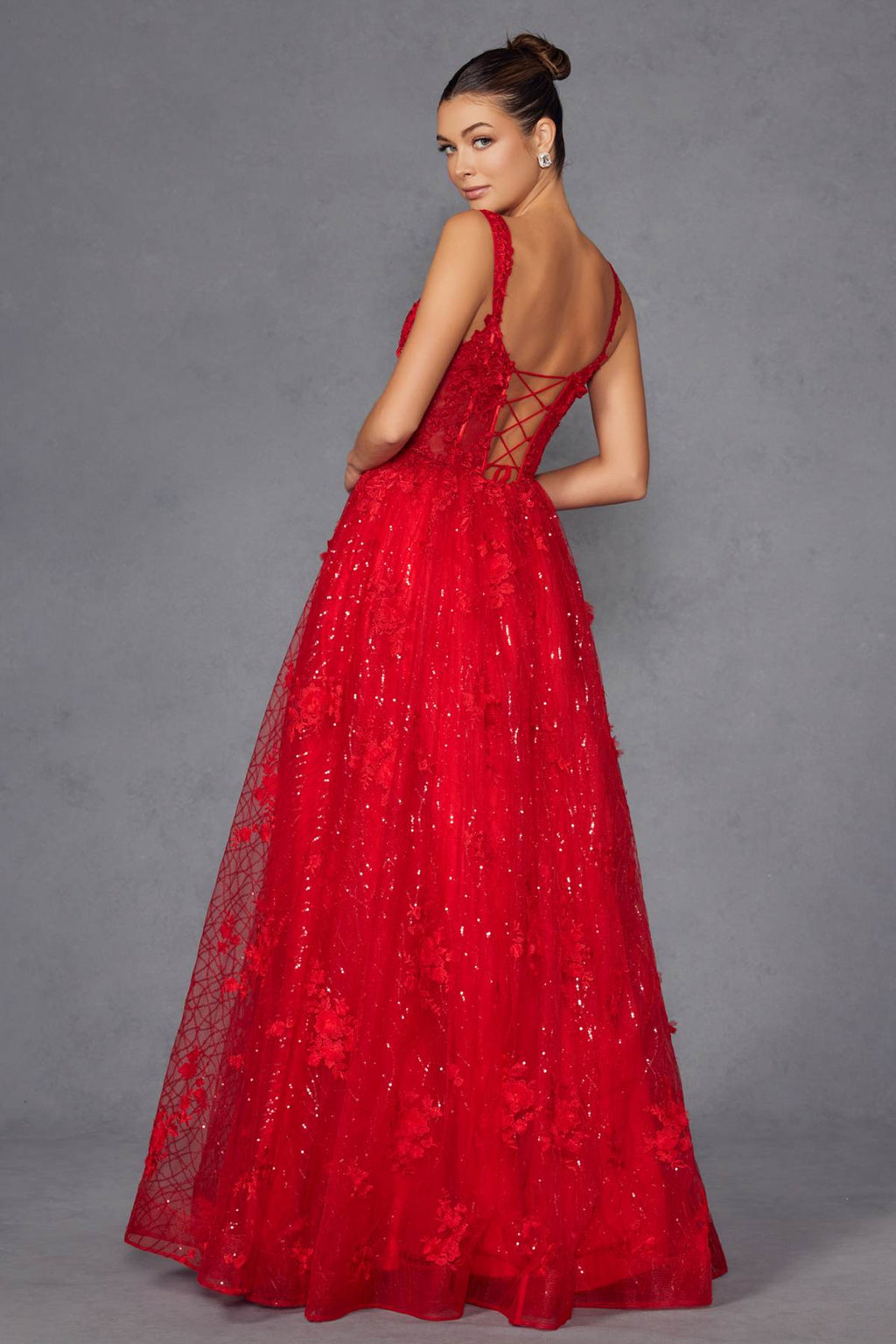 Red A-line evening gown with crisscross back straps and full glittering skirt