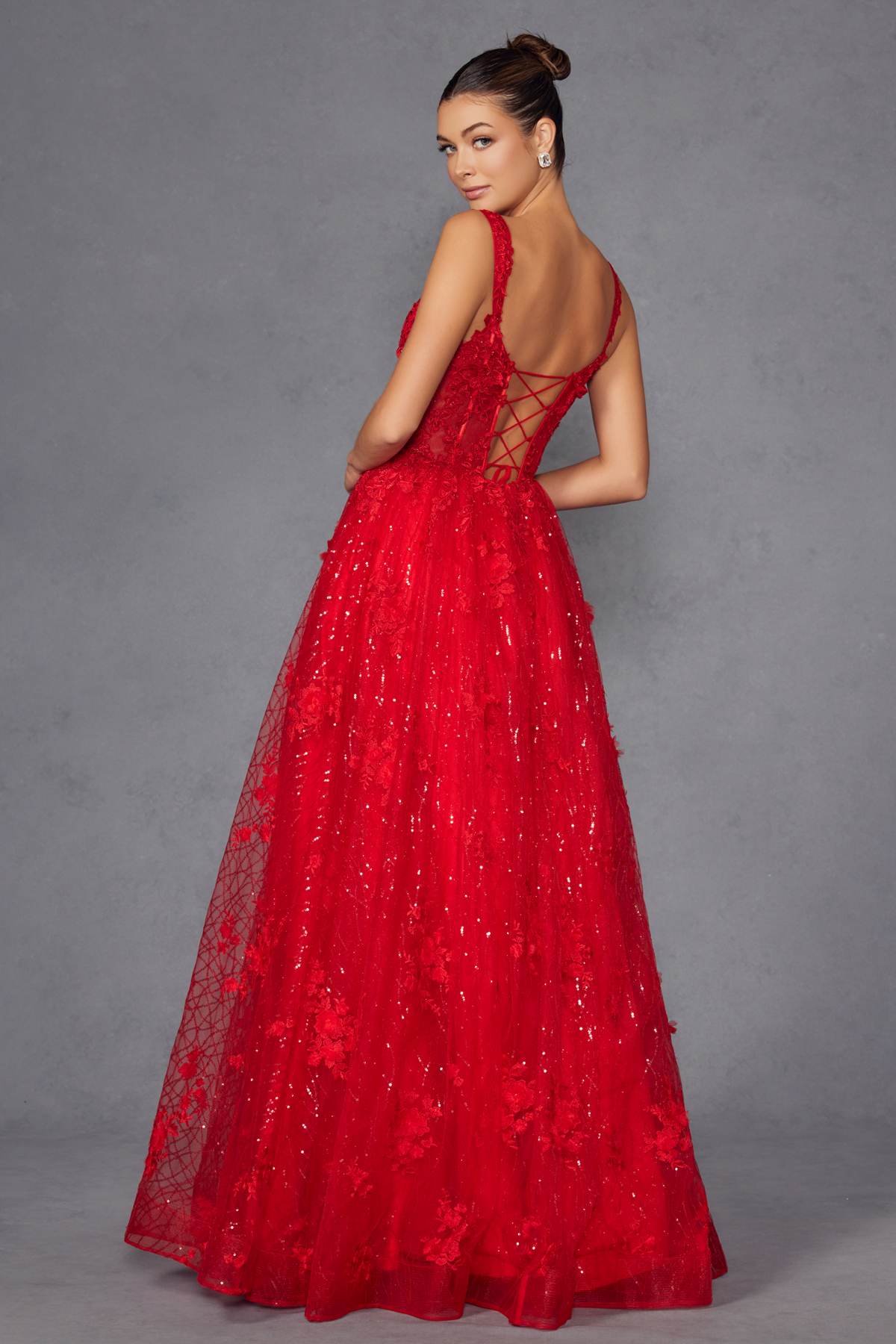 Red A-line evening gown with crisscross back straps and full glittering skirt