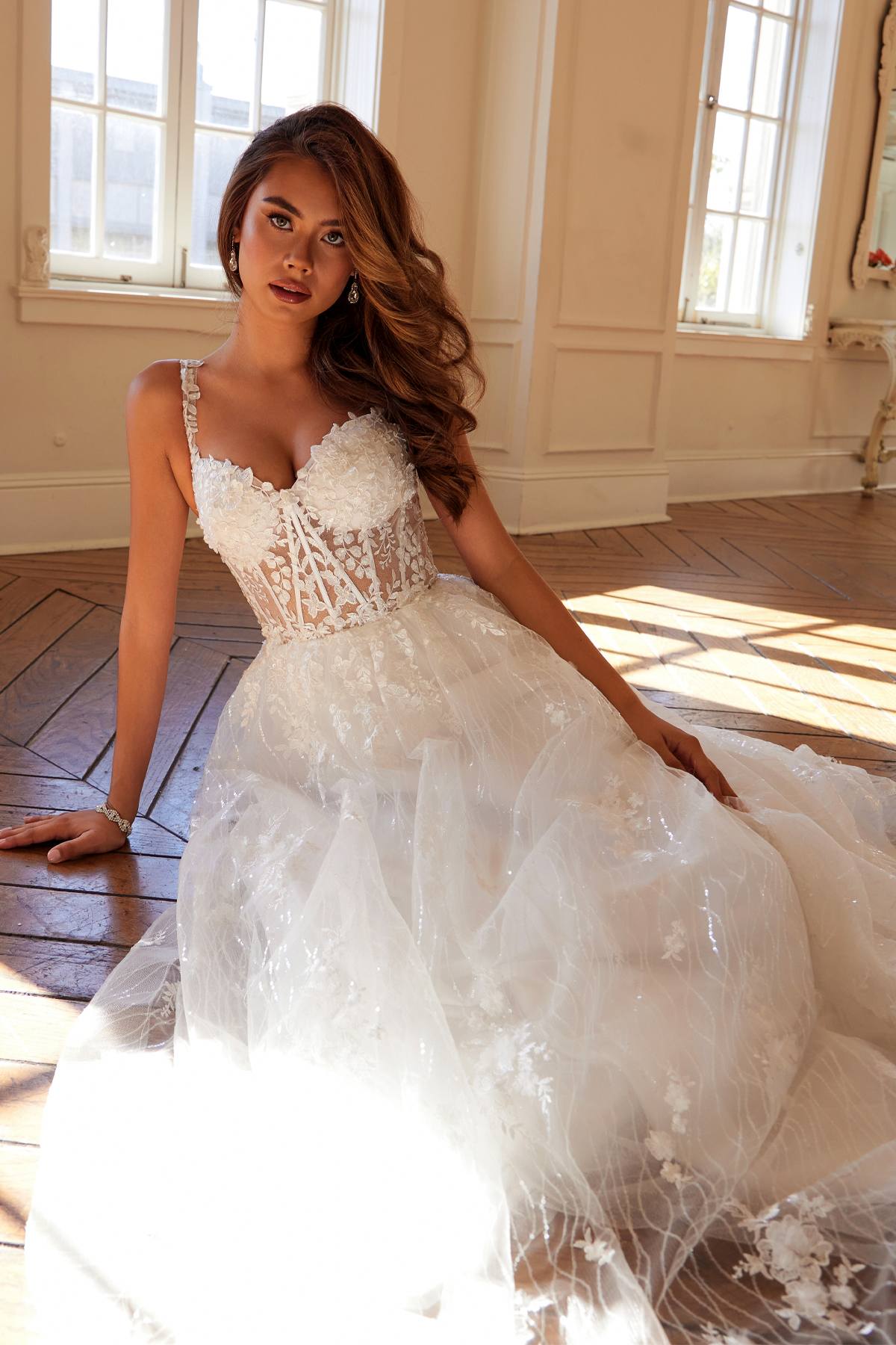 Off-white long A-line bridal gown with floral lace bodice and textured tulle skirt