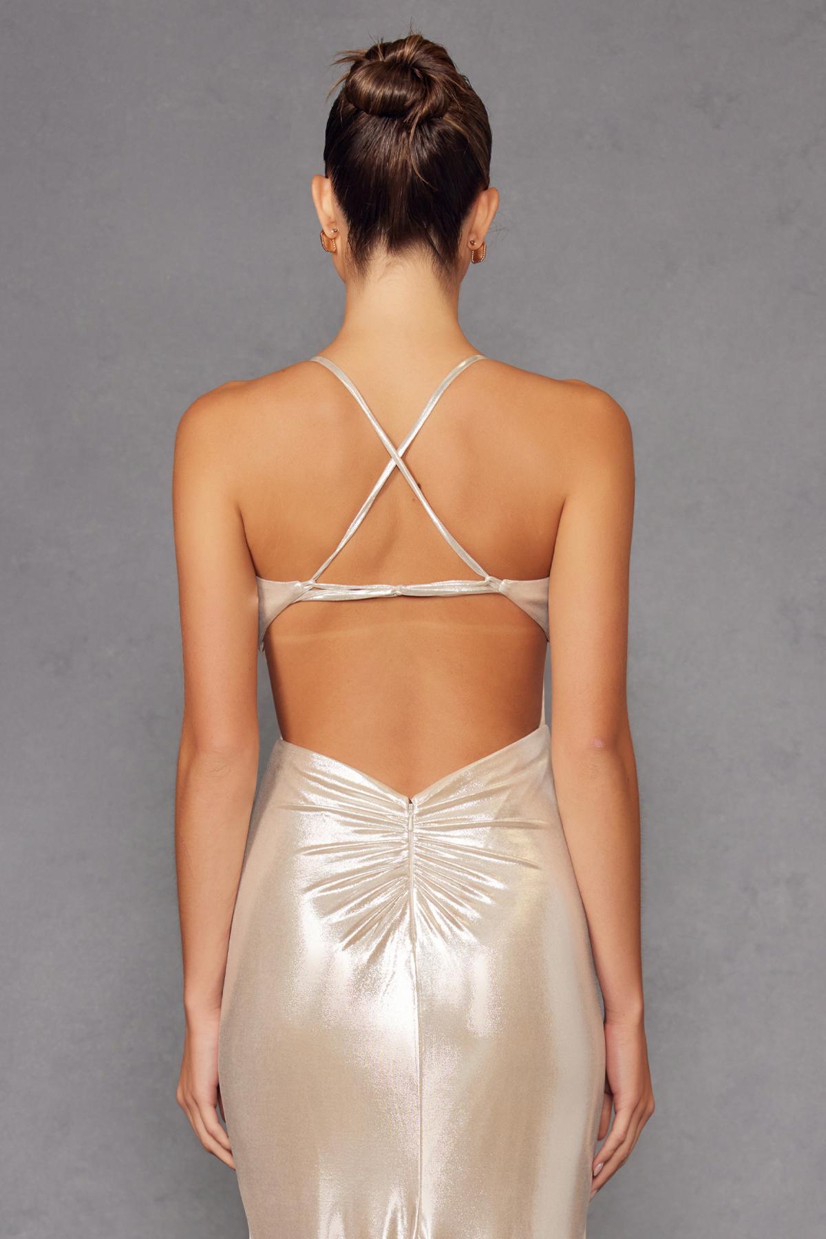 Champagne metallic halter backless gown with crisscross straps and long skirt