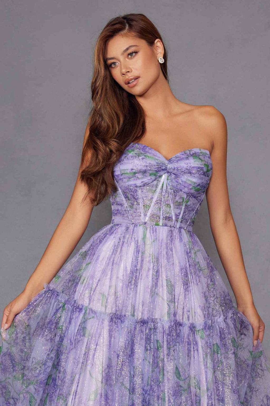 Lilac strapless sweetheart tiered gown with watercolor floral print and gathered bodice.