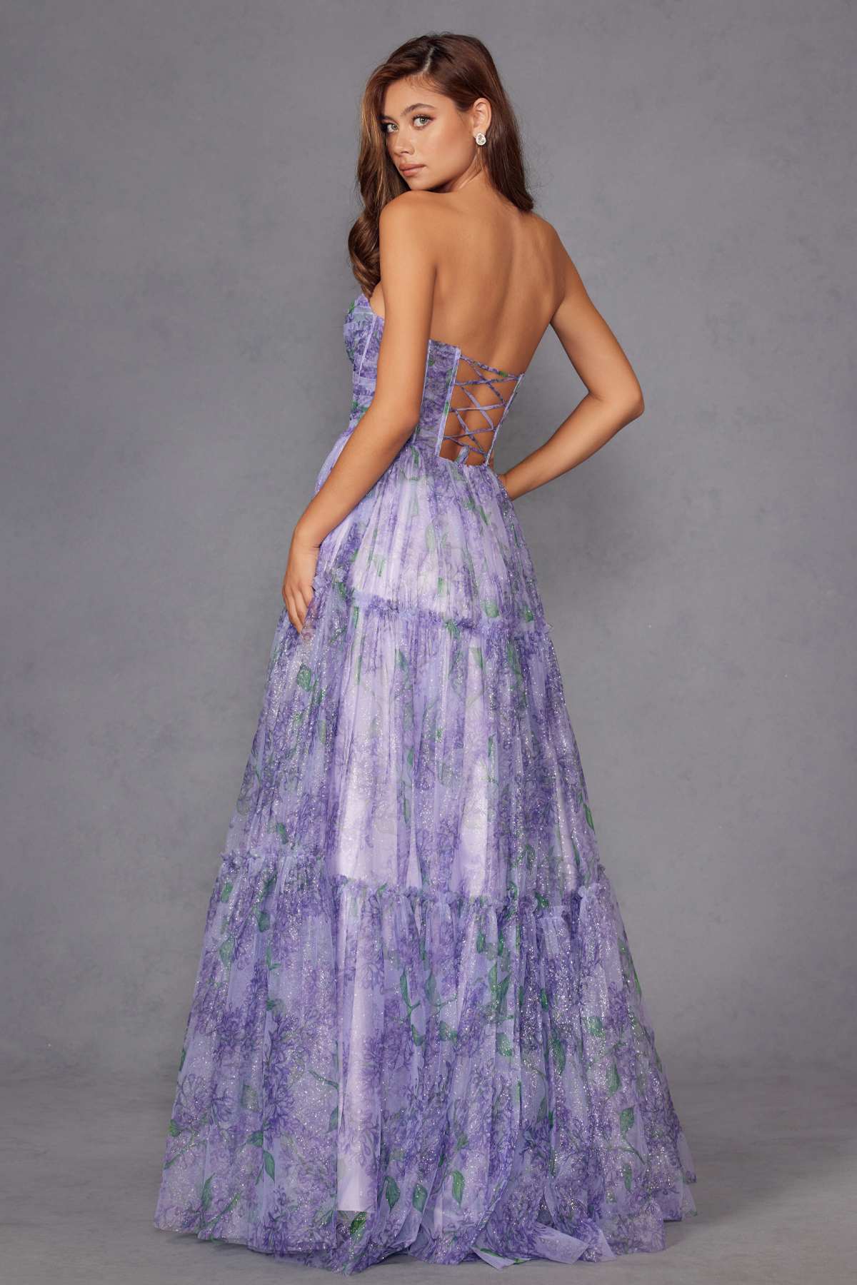 Lilac tiered gown with watercolor floral print, back view with crisscross corset lacing.