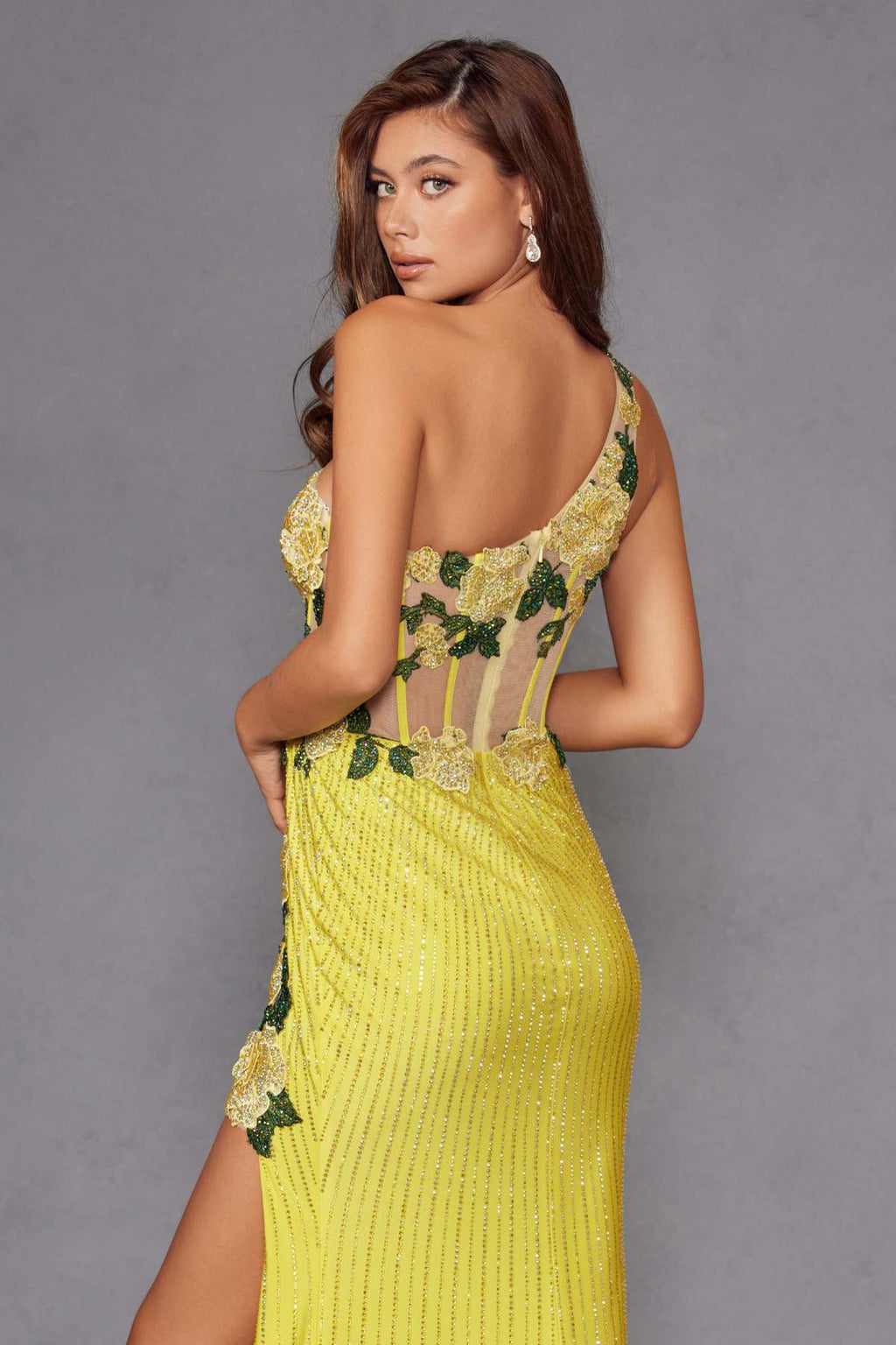 Backless one-shoulder evening gown in bright yellow with green floral applique