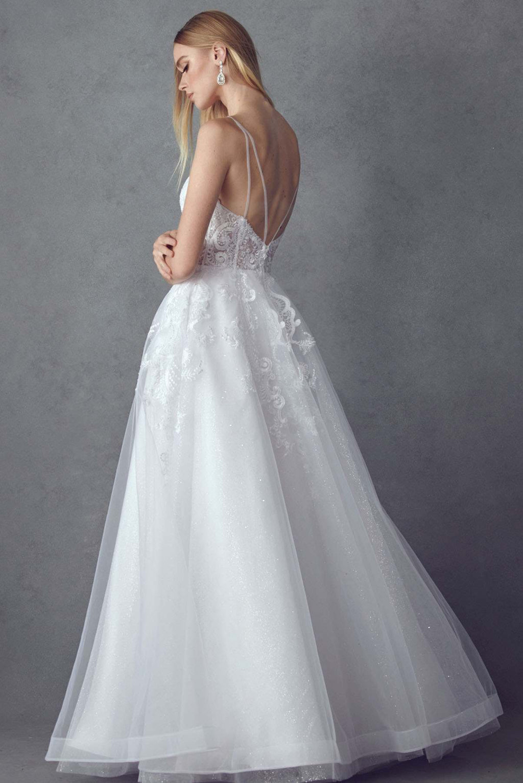 White A-line tulle wedding ball gown from side/back view with lace bodice and straps