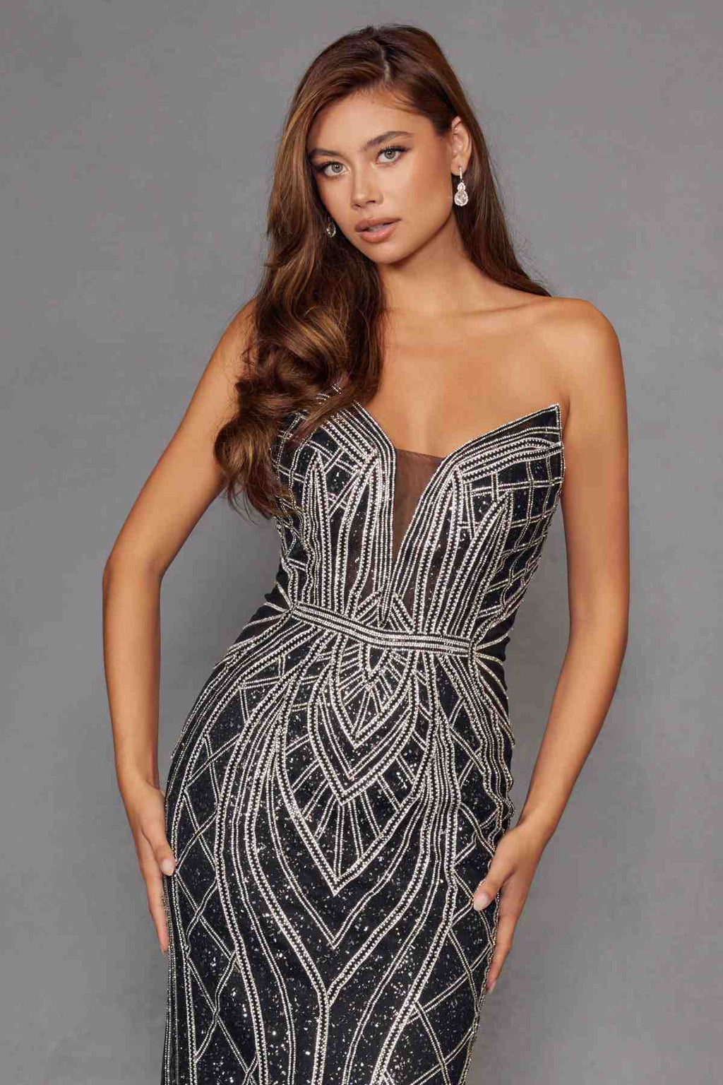 Strapless fitted evening gown with silver geometric bead pattern and sweetheart neckline, long hem.