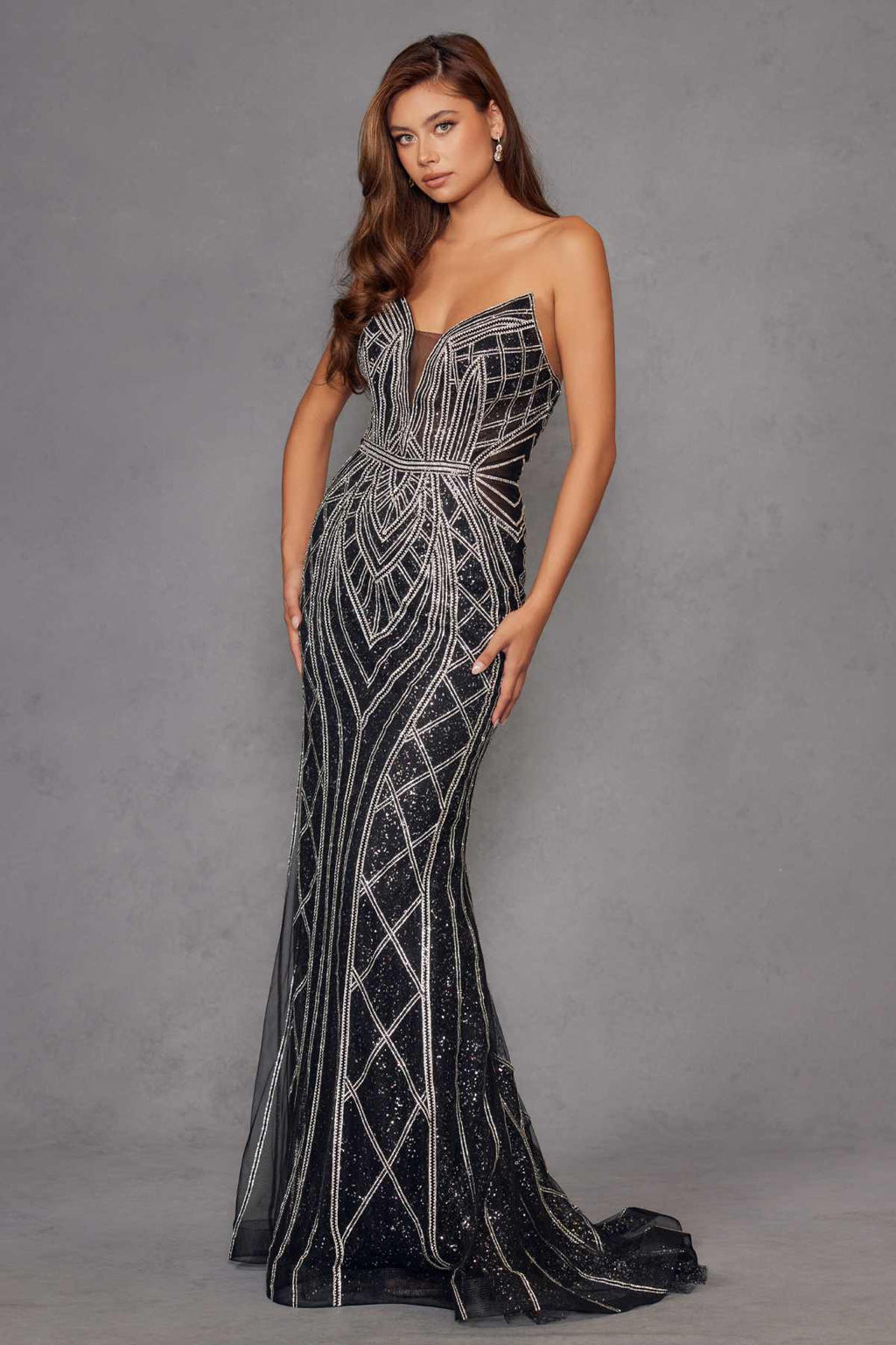 Strapless fitted evening gown with silver beaded geometric design on dark fabric, floor-length.
