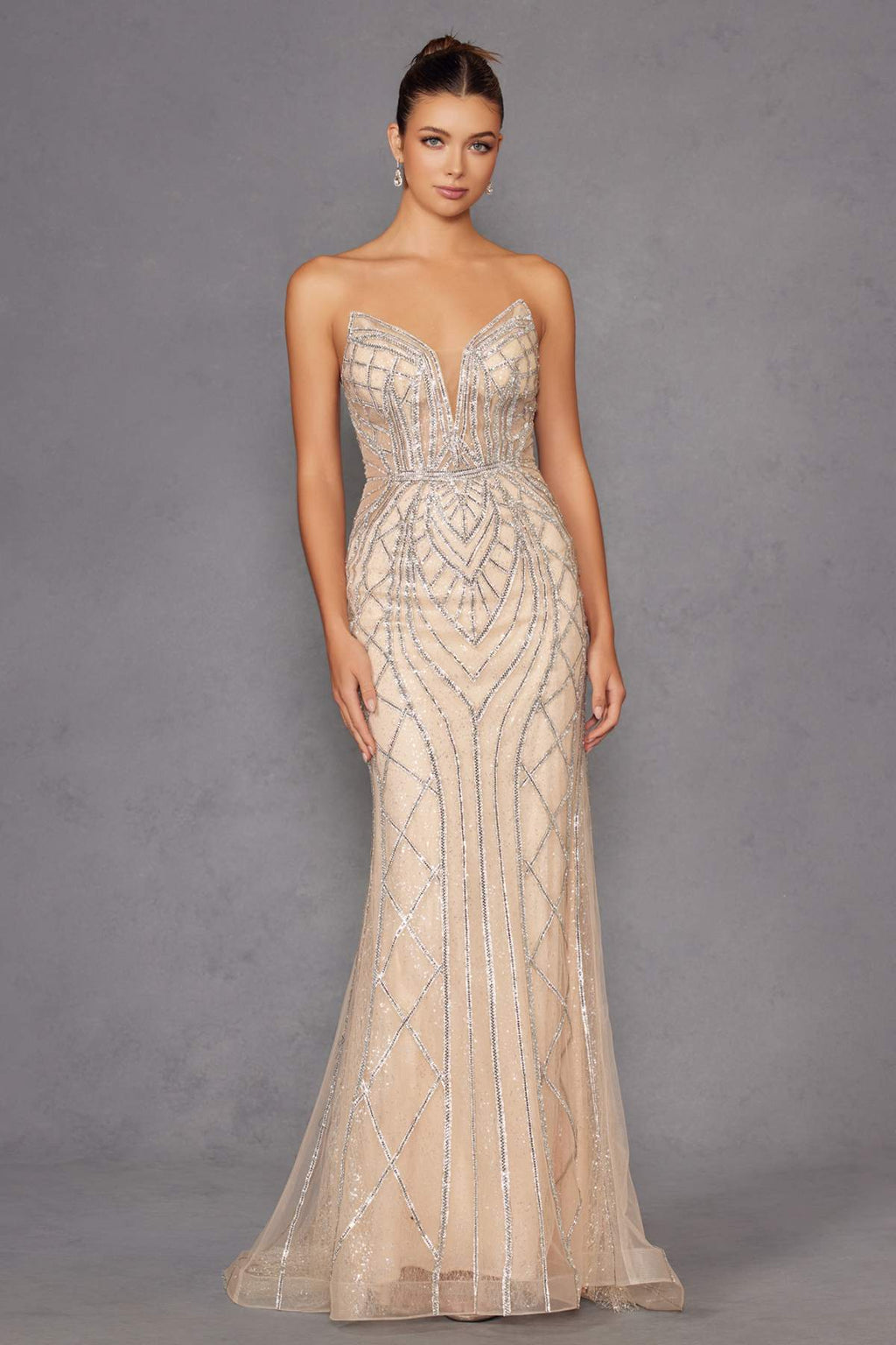 Strapless fitted evening gown in champagne with silver geometric beadwork, long flowing skirt.