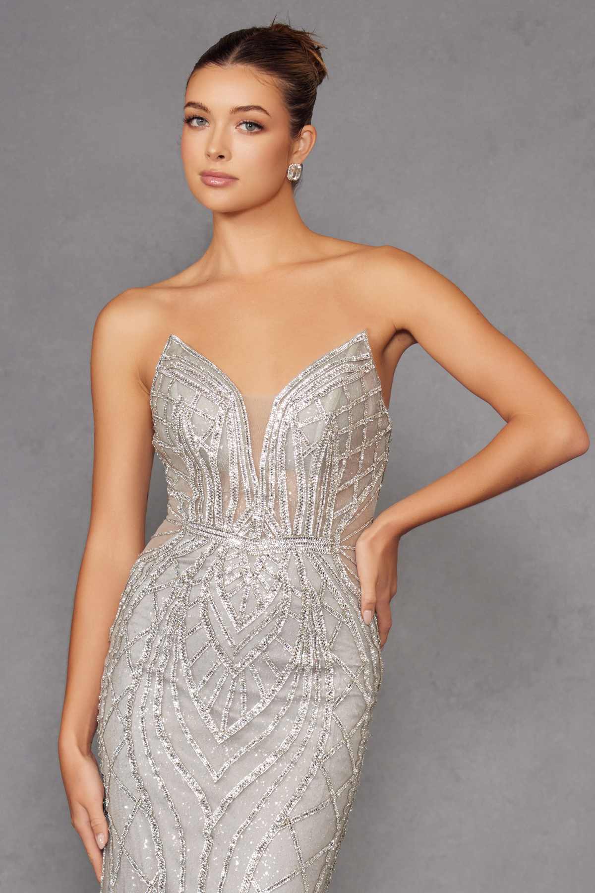 Silver strapless fitted evening gown with ornate beaded pattern and sweetheart neckline