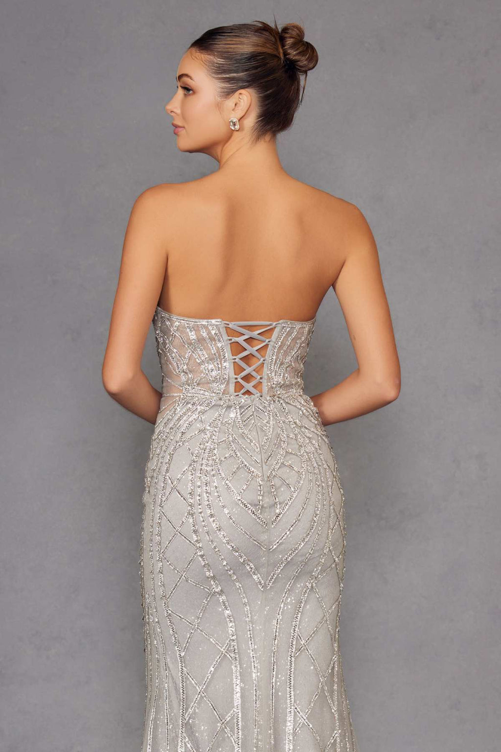 Silver strapless evening gown back view with crisscross lace-up detail