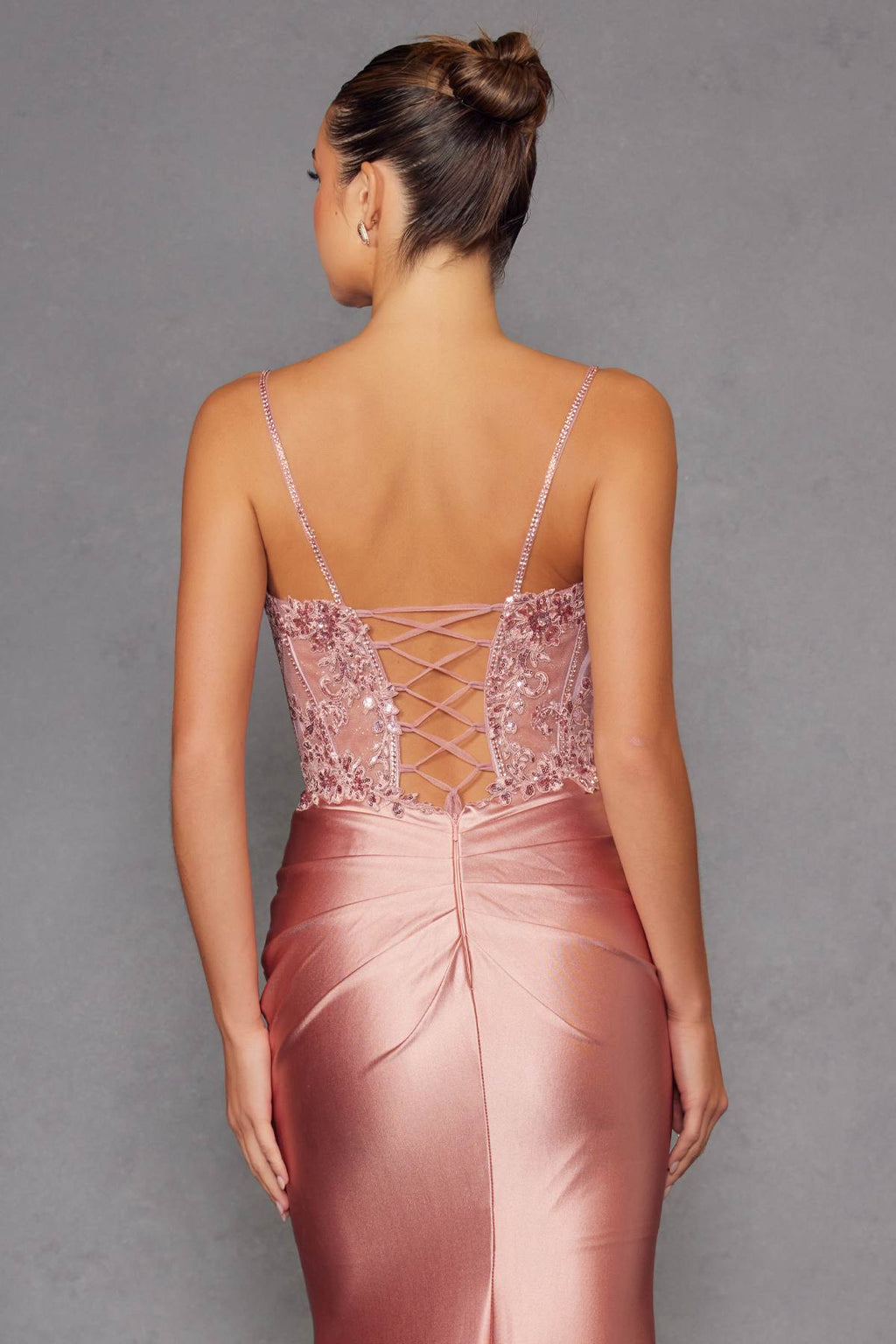 Rose gold satin prom gown back view with crisscross lace-up detail and beaded straps