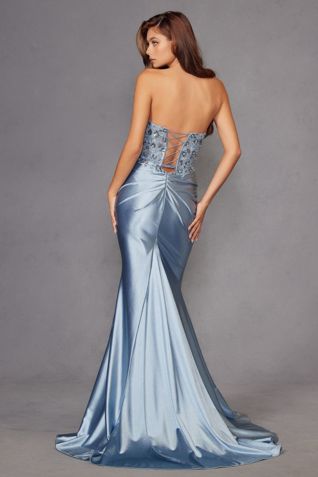 Light blue strapless corset prom gown with beaded bodice and ruched satin drape at waist