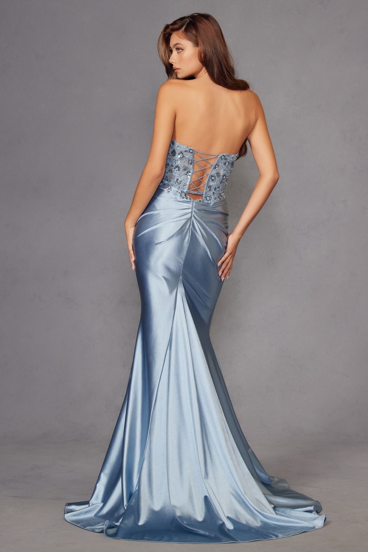 Light blue strapless corset prom gown with beaded bodice and ruched satin drape at waist