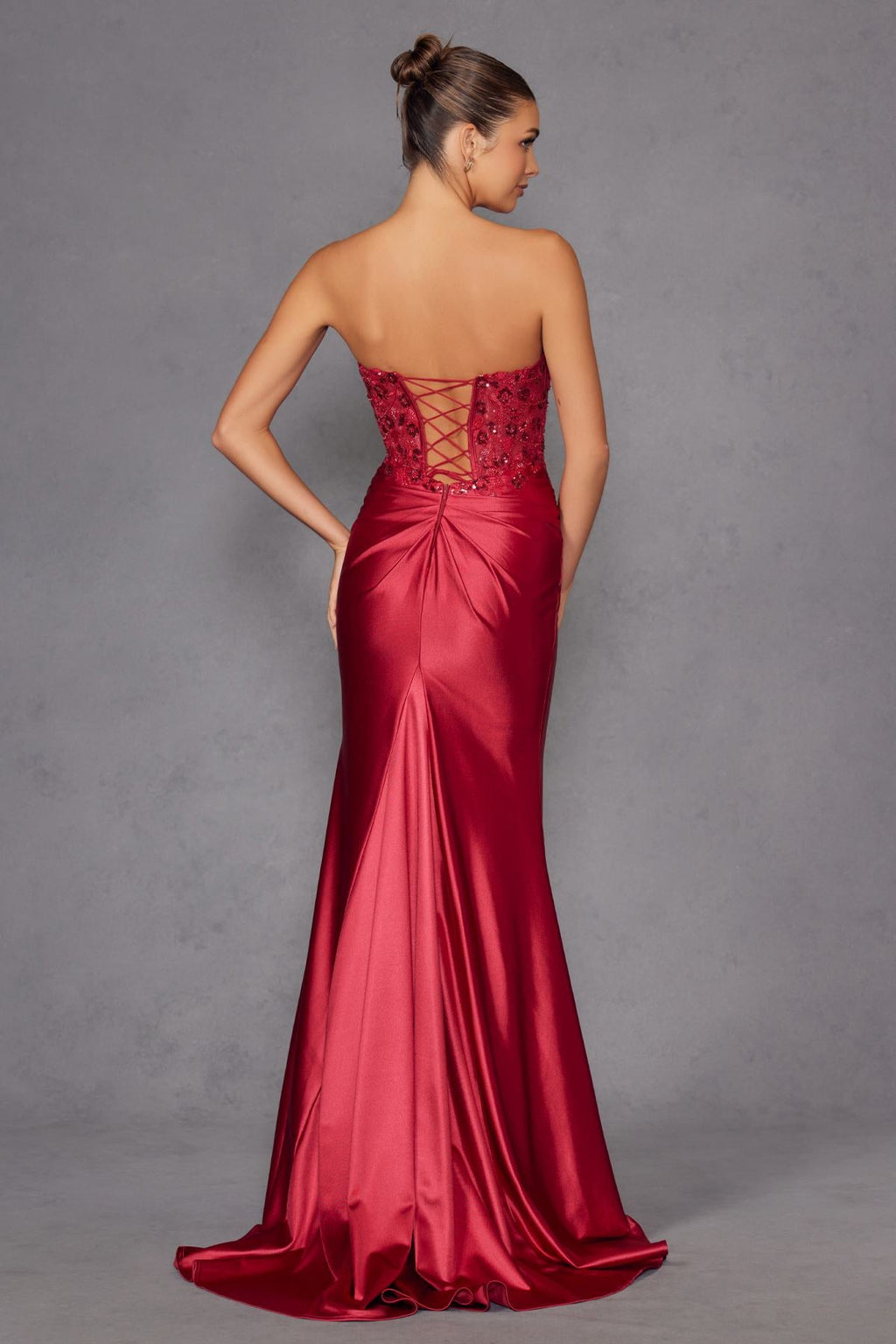 Strapless corset prom gown in dark red satin with beaded back and draped waist