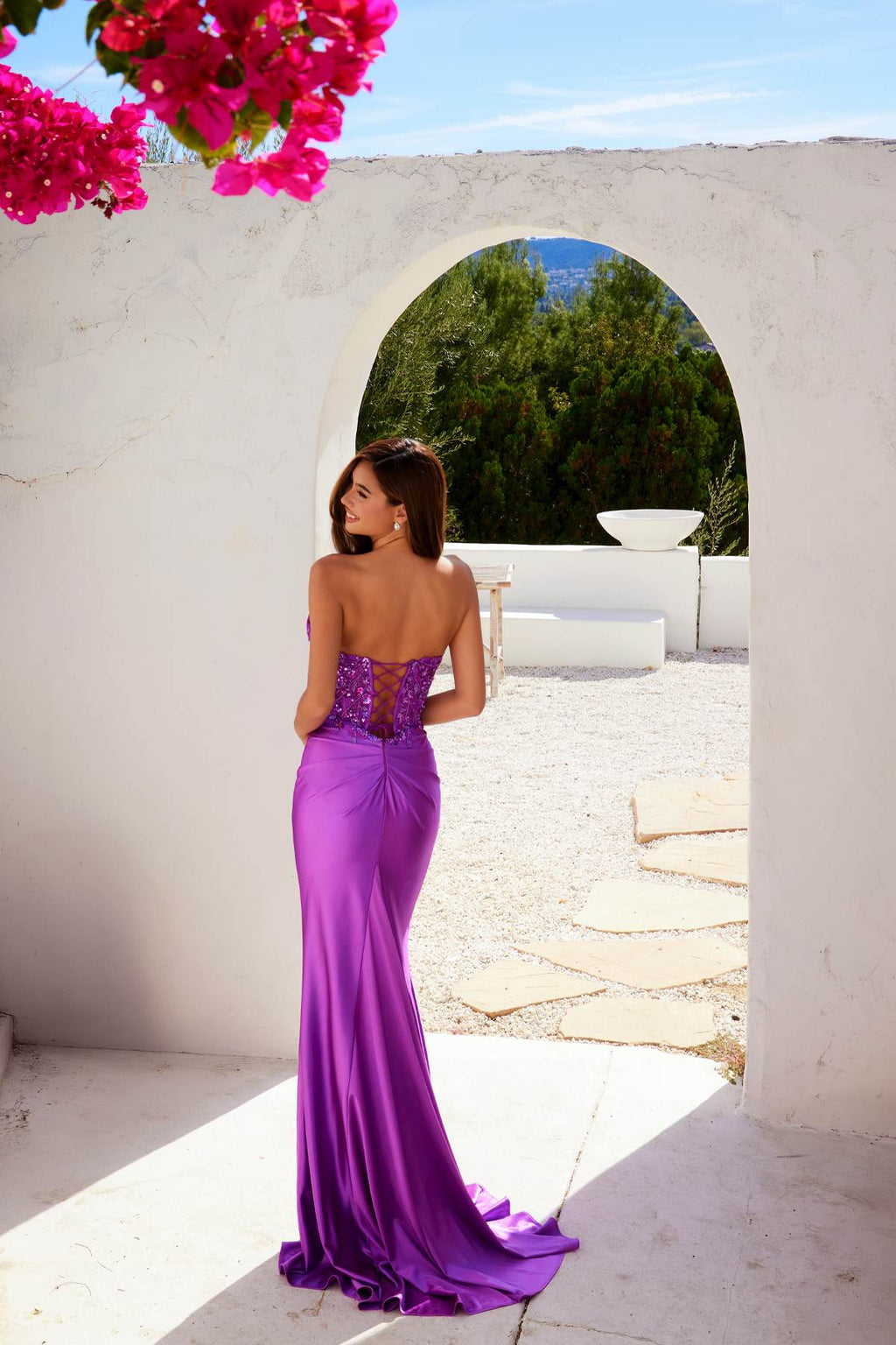 Strapless corset prom gown in purple satin with beaded back and fitted silhouette