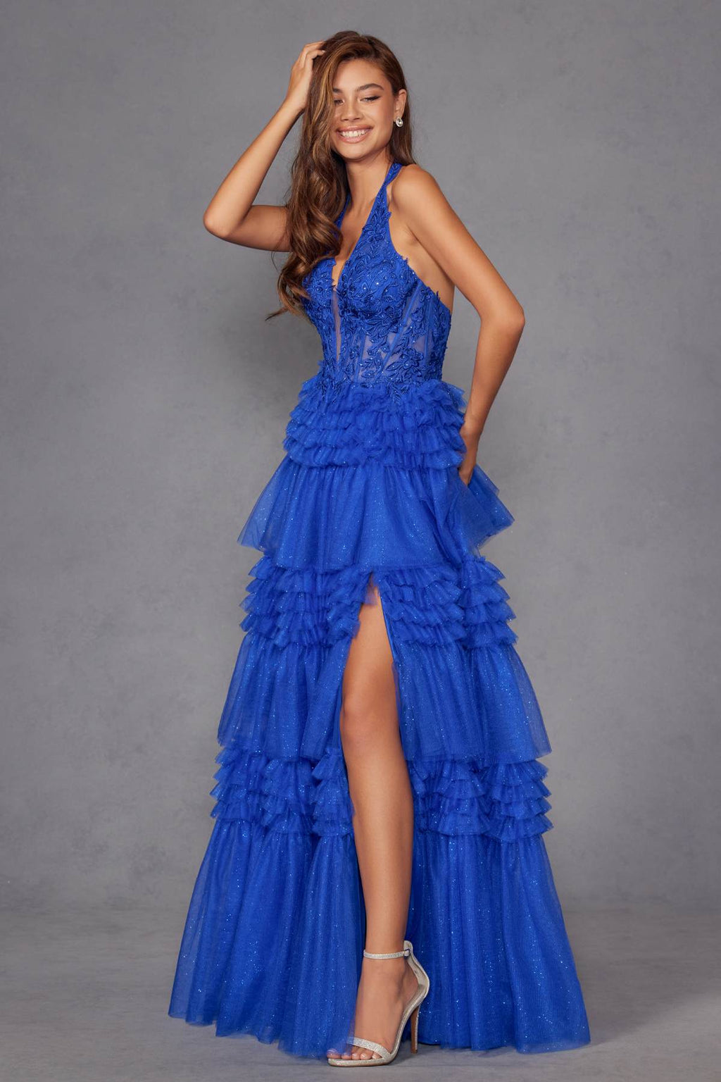 Royal blue halter V-neck tiered tulle A-line gown with thigh slit and layered ruffles