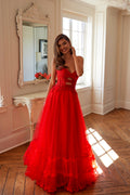 Red strapless sweetheart gown with lace bodice, keyhole cutout, and tiered A-line tulle skirt