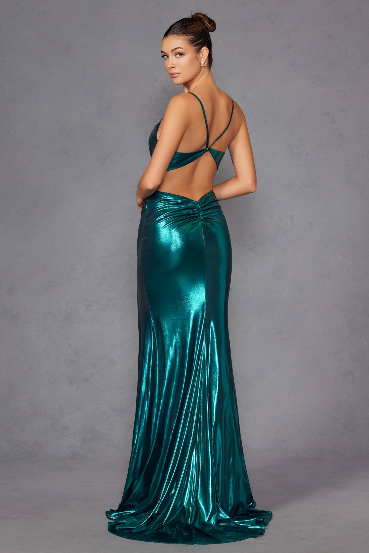 Teal metallic fitted evening gown from back angle with thin straps and ruched skirt; slit.