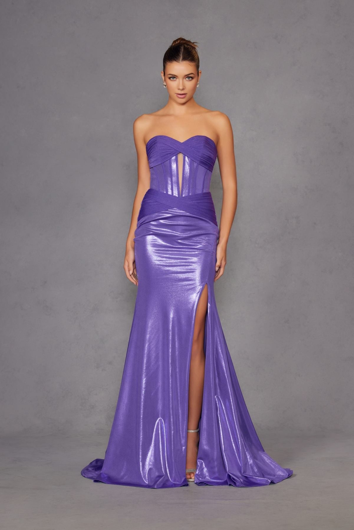Purple strapless sweetheart metallic prom gown with corset bodice and dramatic front slit.