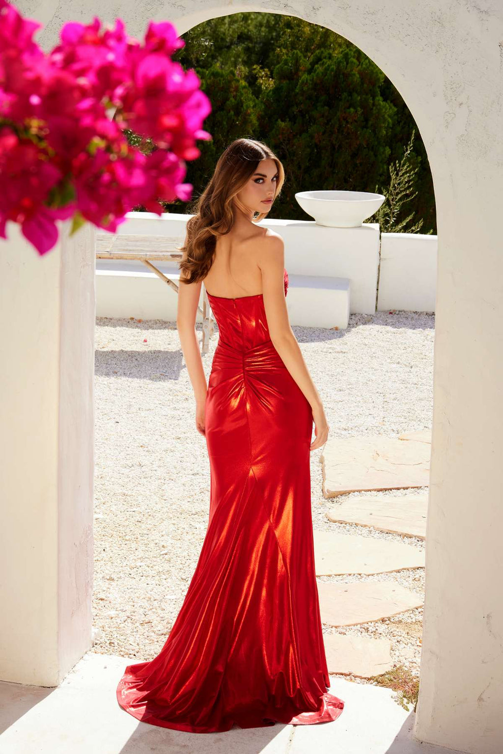 Red metallic strapless sweetheart fitted prom gown, front view with side slit
