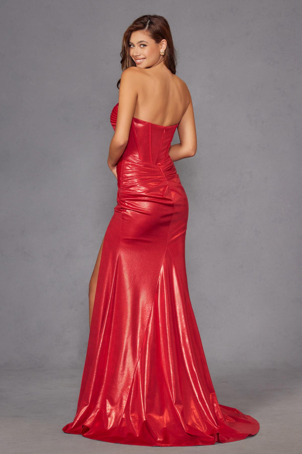 Red metallic strapless fitted prom gown, back view with flowing long skirt