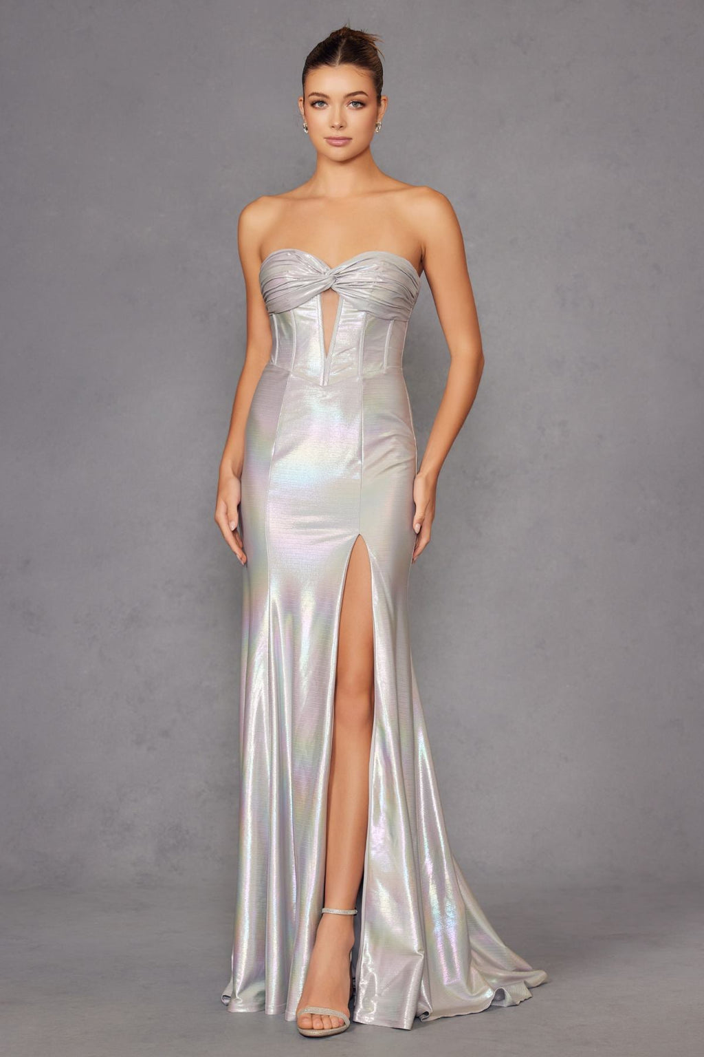 Iridescent strapless sweetheart prom gown in silver satin with bow-twist bodice and thigh slit