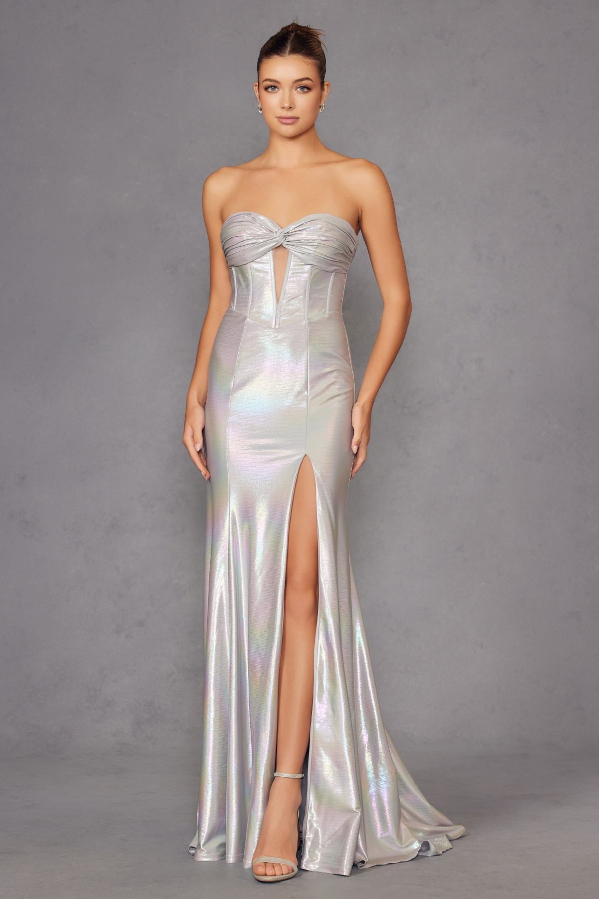 Iridescent strapless sweetheart prom gown in silver satin with bow-twist bodice and thigh slit