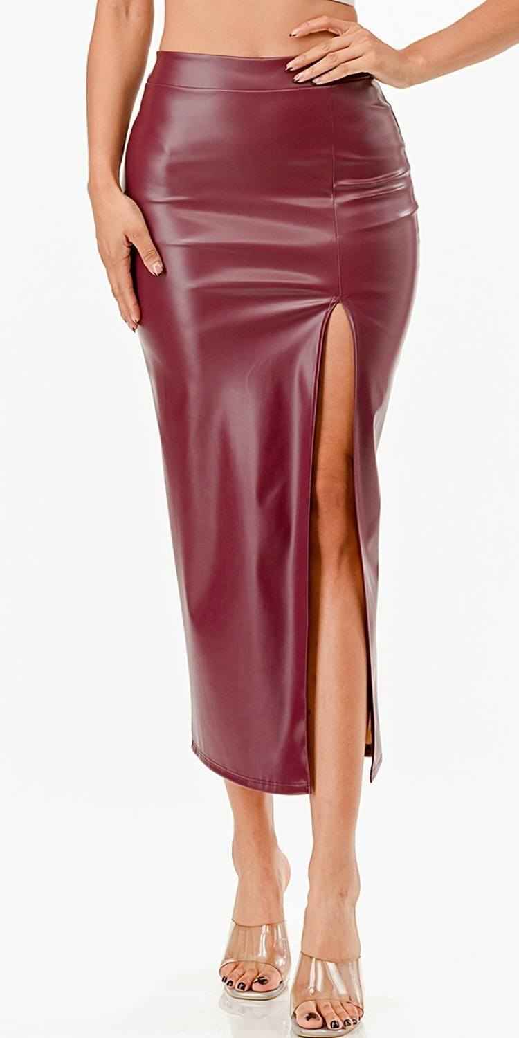 Mid-length burgundy faux leather pencil skirt with a front slit and smooth finish.