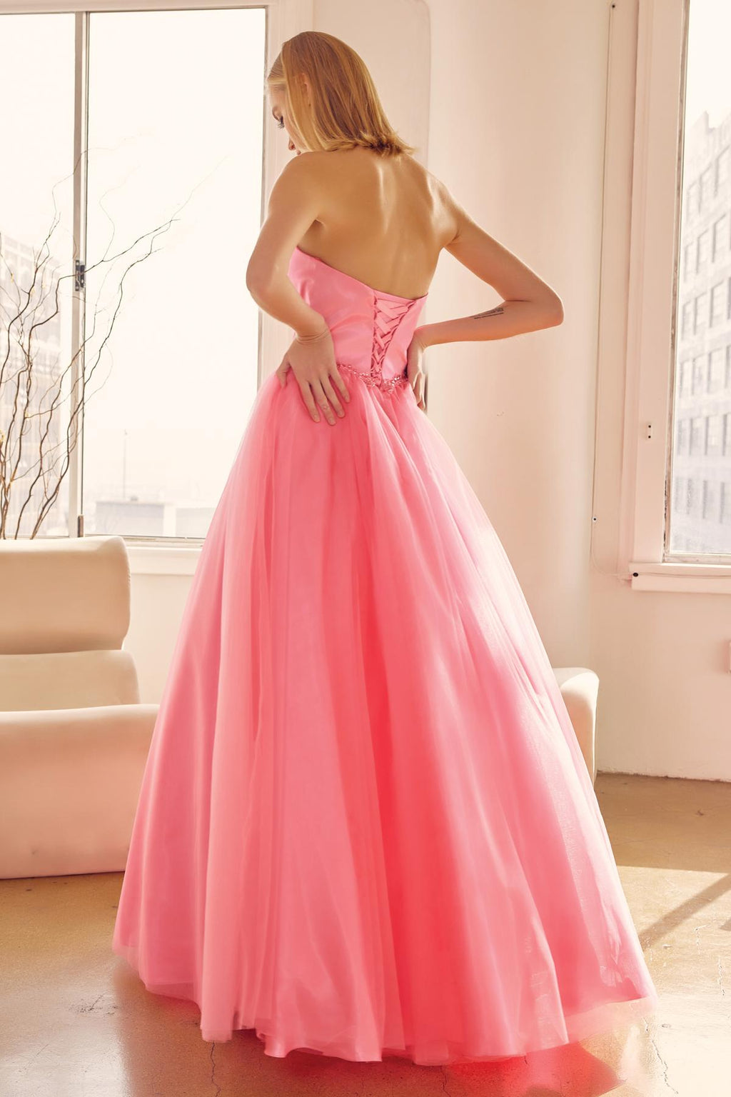 Hot pink strapless A-line ball gown with sweetheart bodice and beaded belt, back view