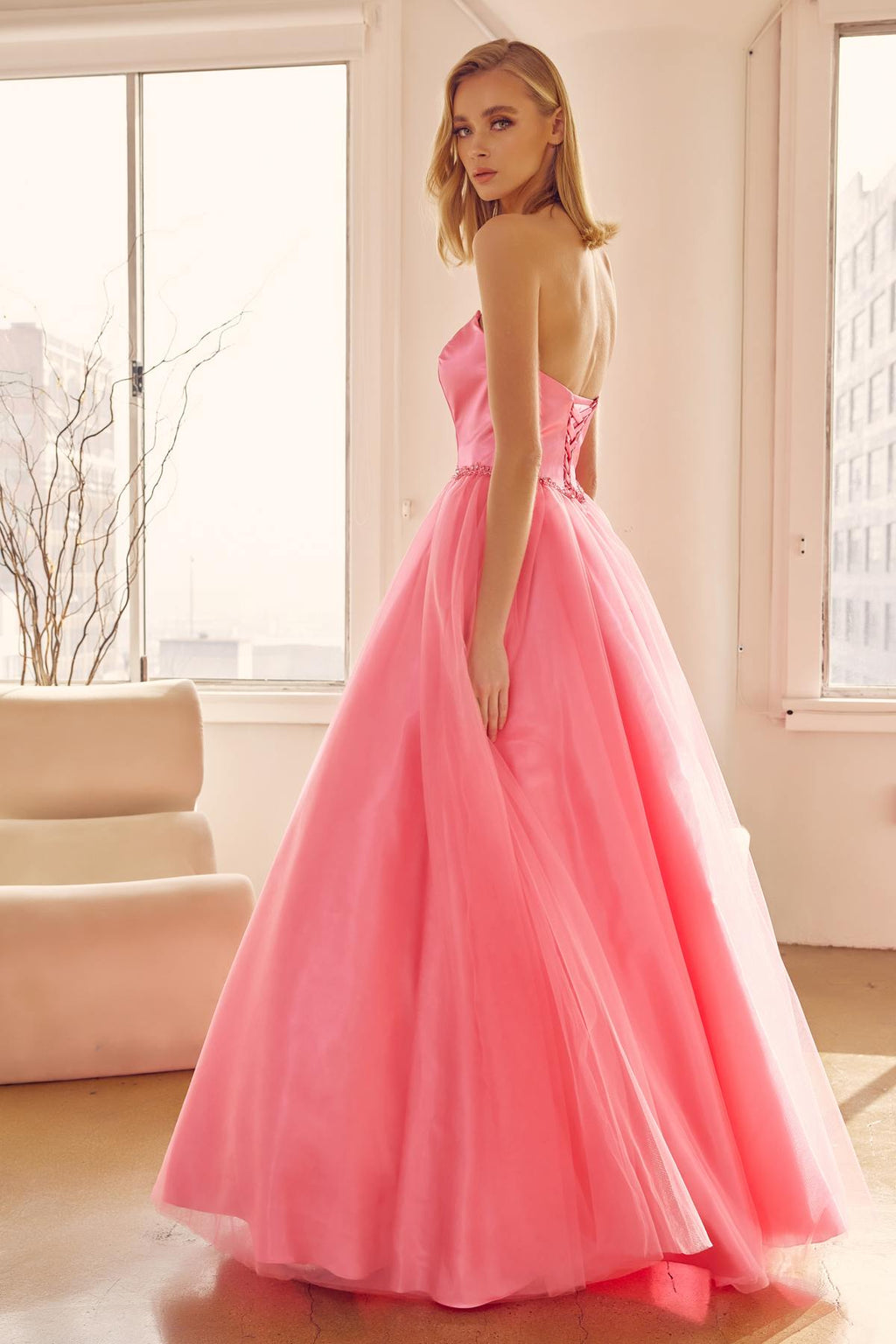 Hot pink strapless A-line ball gown with sweetheart bodice and beaded belt, side view