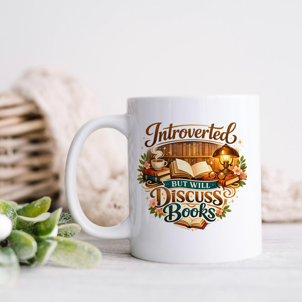 White ceramic coffee mug with colorful "Introverted, but will discuss books" quote