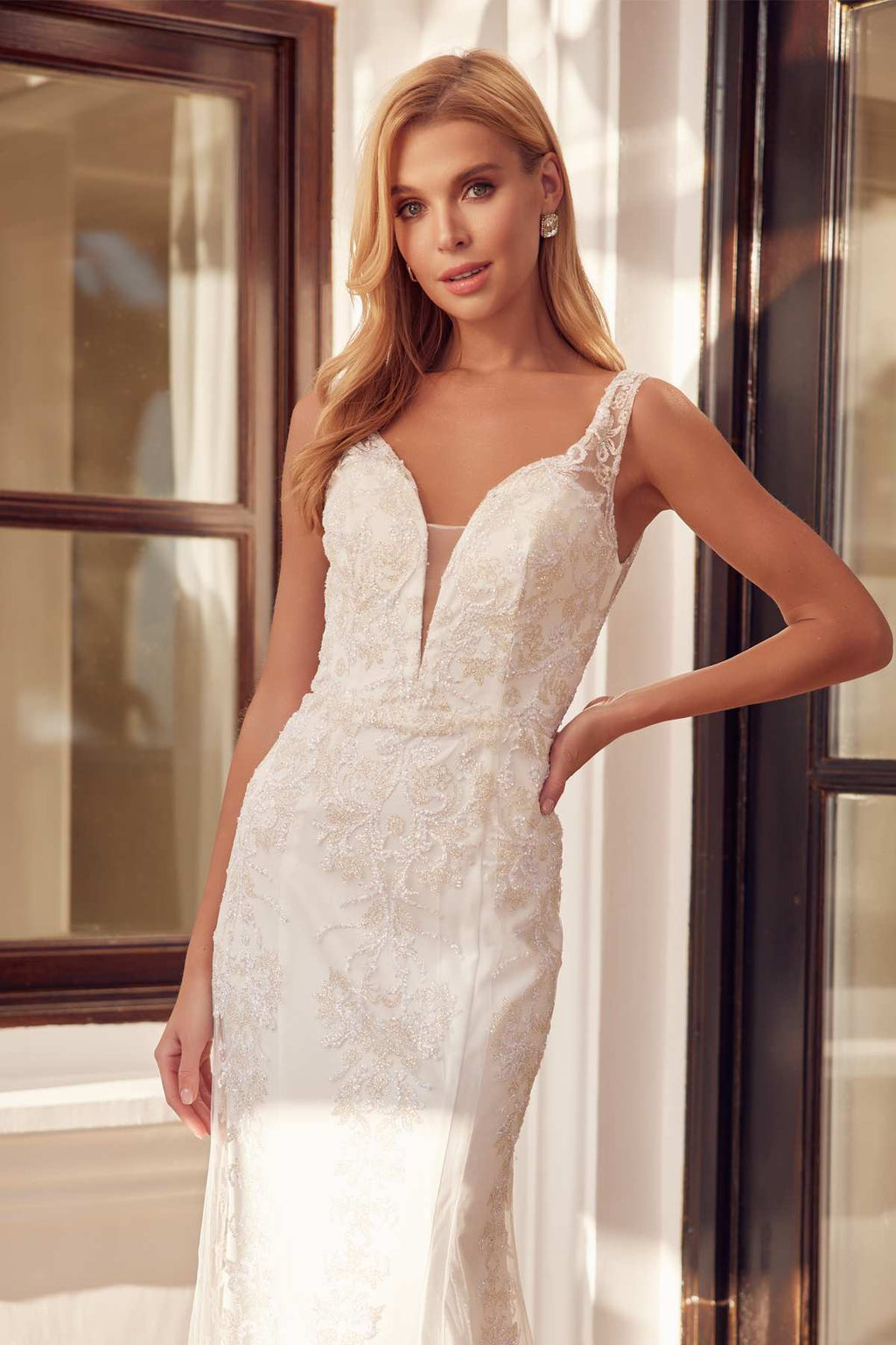 Off-white mermaid wedding dress with deep V bodice and textured lace appliques