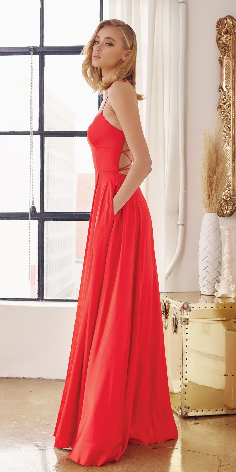 Red satin A-line formal gown with thin straps and flowing pleated skirt
