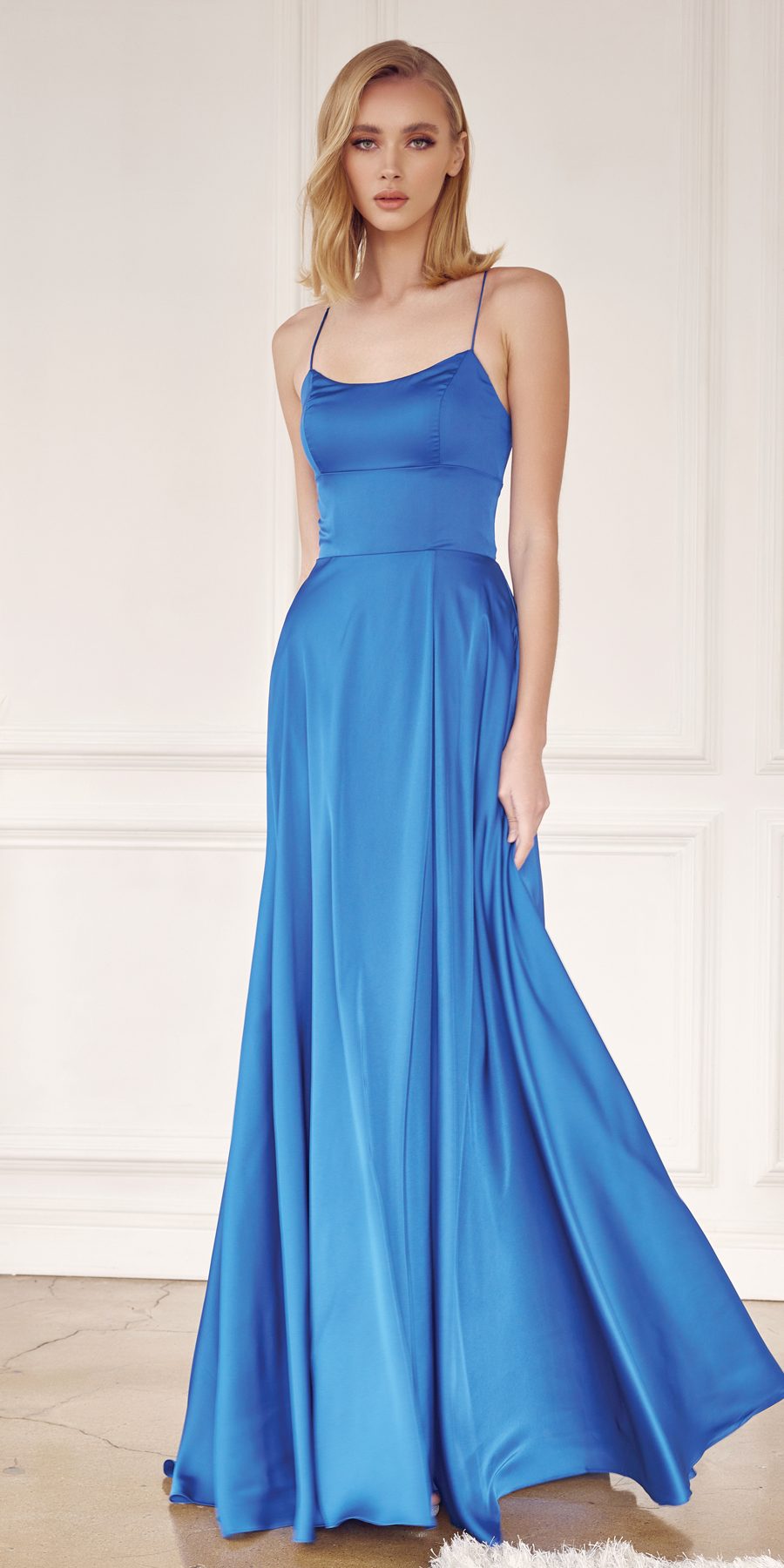 Blue satin A-line formal gown with spaghetti straps and layered flowing skirt