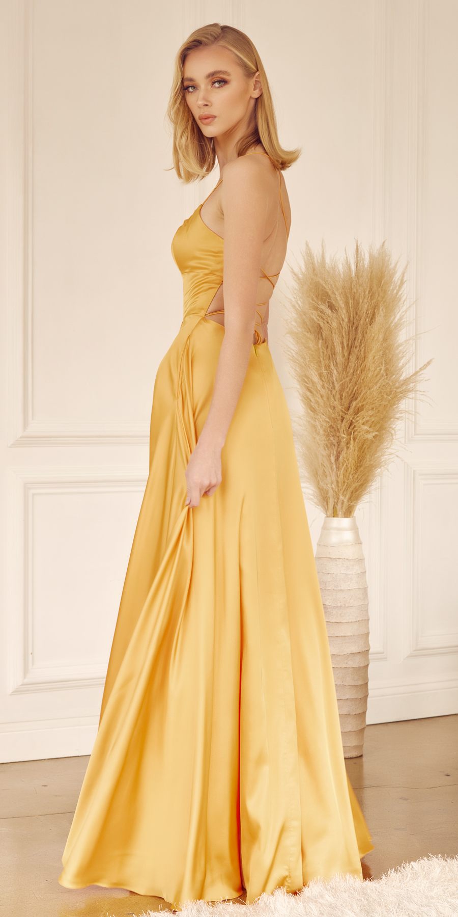 Yellow satin A-line gown with thin straps and draped skirt