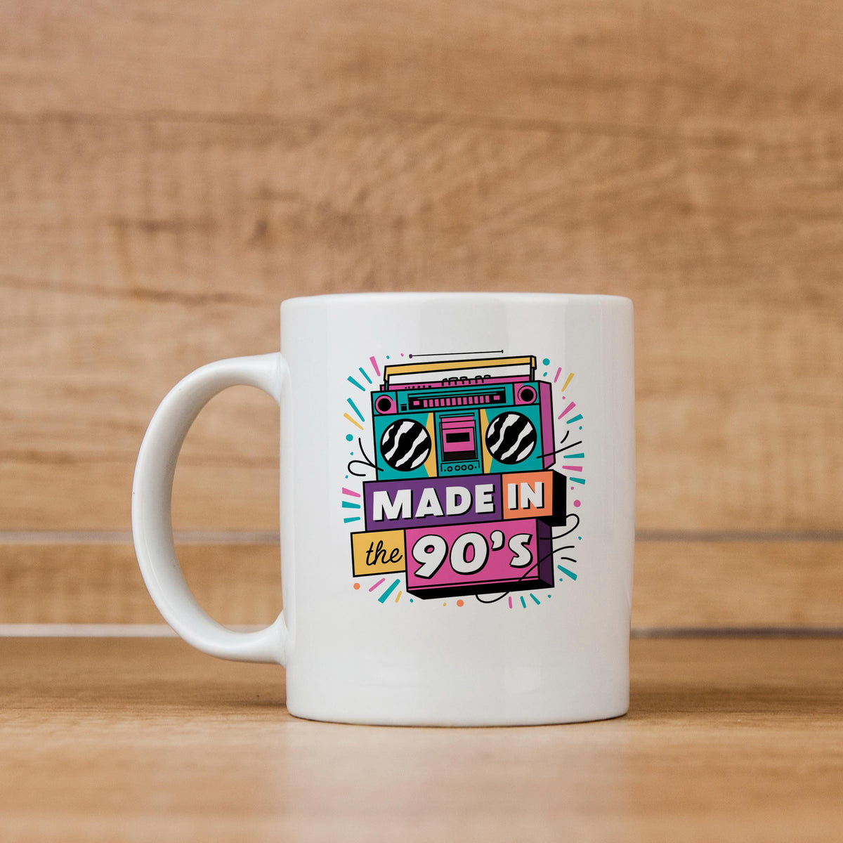 White ceramic mug with “Made in the 90’s” boombox graphic, side view