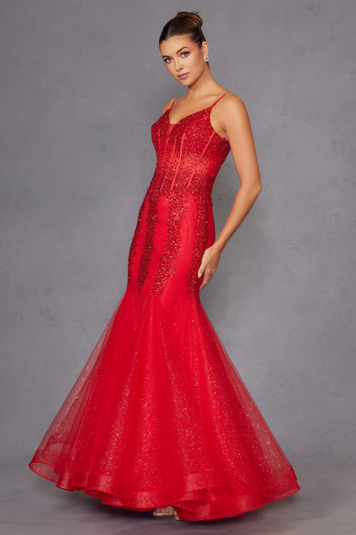 Red embellished mermaid gown with fitted corset and thin straps, three-quarter view