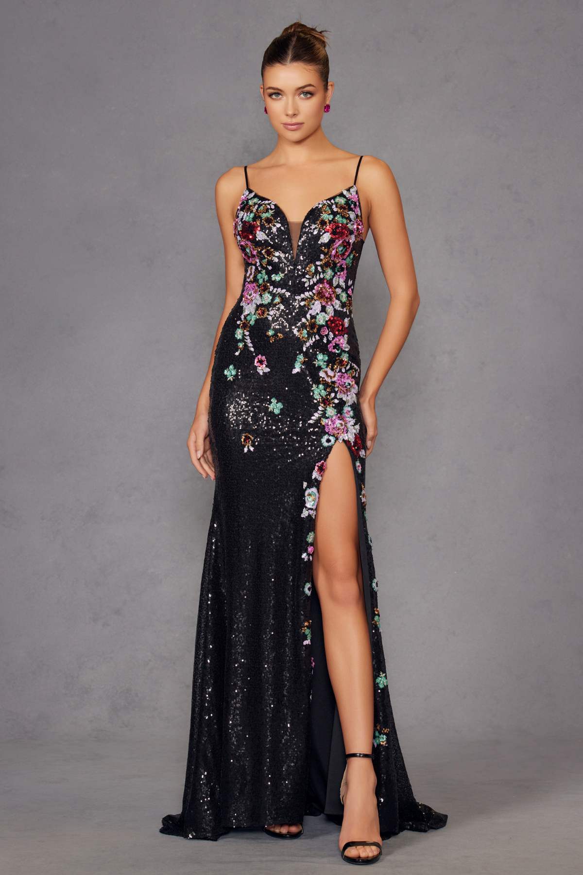 Black sequin prom gown with floral embroidery, sweetheart neckline, thigh-high slit, straps.