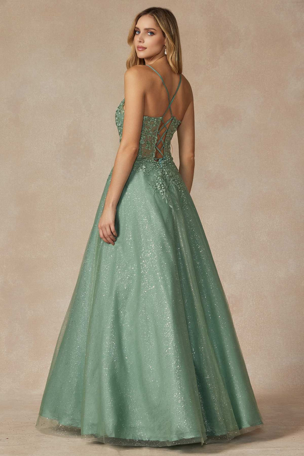 Sage green leaf lace corset prom gown from side angle with thin spaghetti straps.