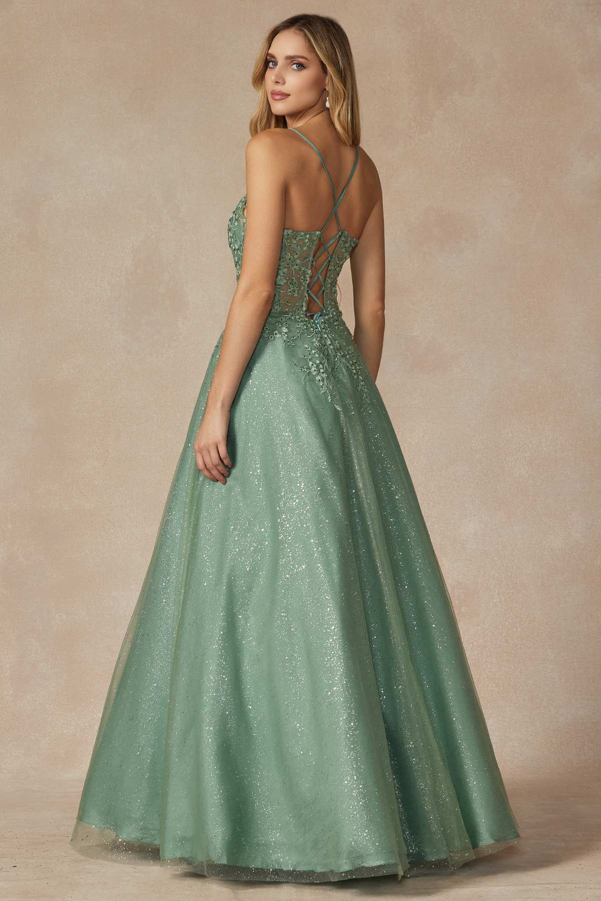 Sage green leaf lace corset prom gown from side angle with thin spaghetti straps.