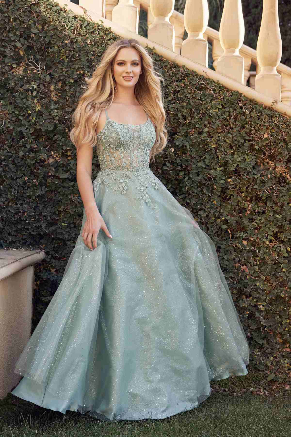 Sage green leaf lace corset prom gown with spaghetti straps and glittery layered skirt.