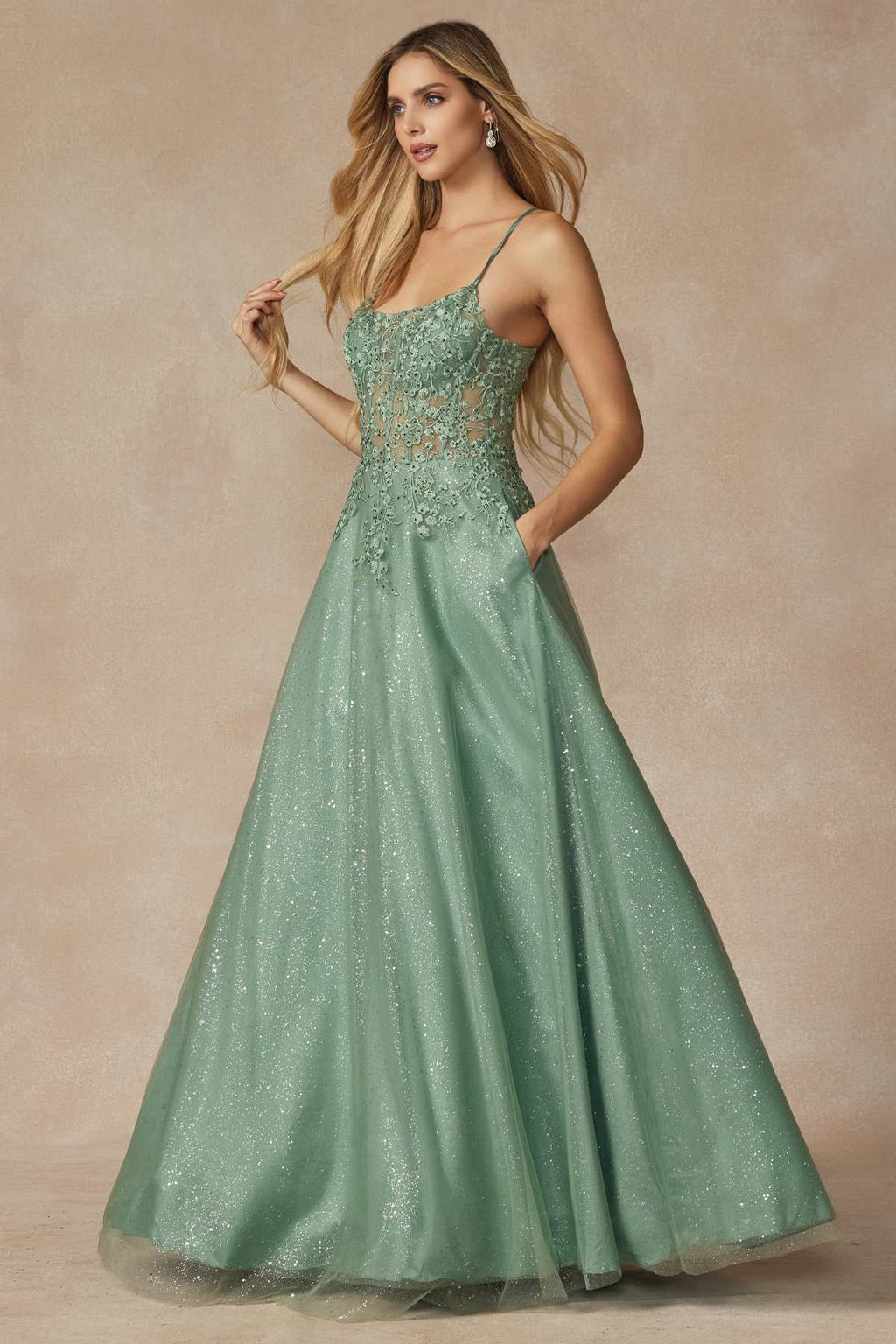 Sage green leaf lace corset prom gown with spaghetti straps and full sparkly skirt.