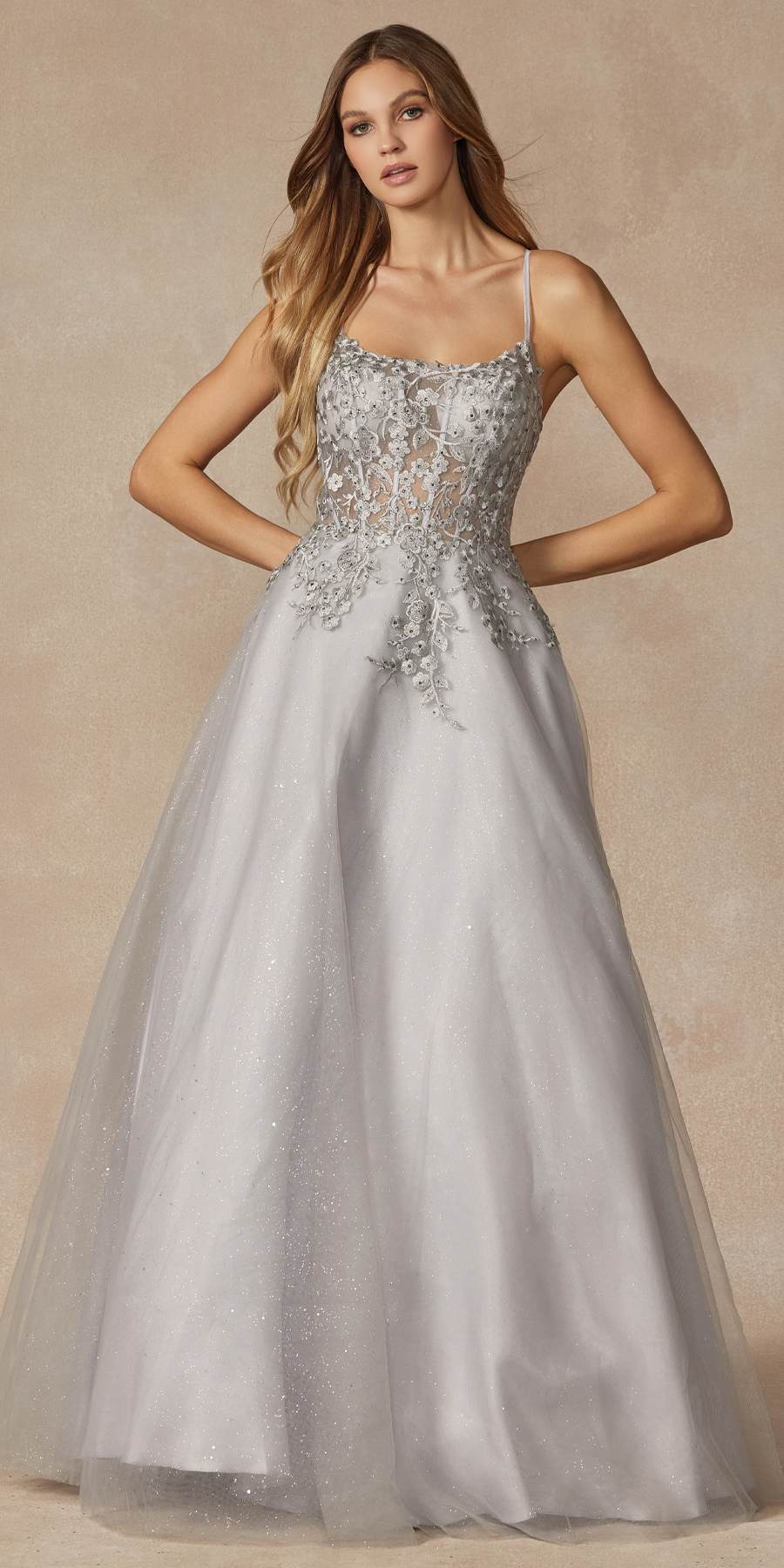 Silver leaf lace corset-style prom gown with thin spaghetti straps and full skirt.