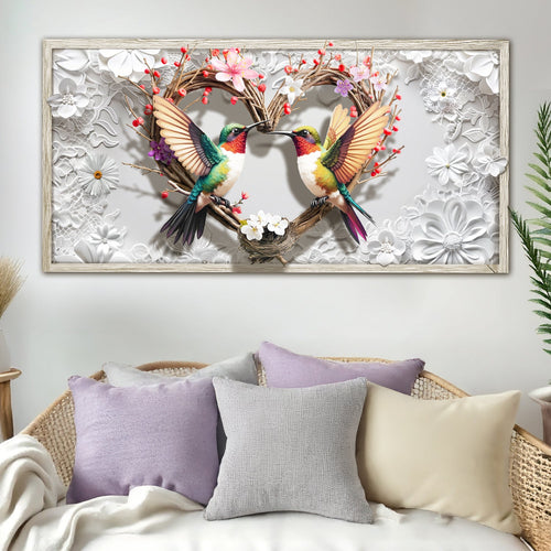 3D hummingbirds wall art in a silver frame above a bed with pillows
