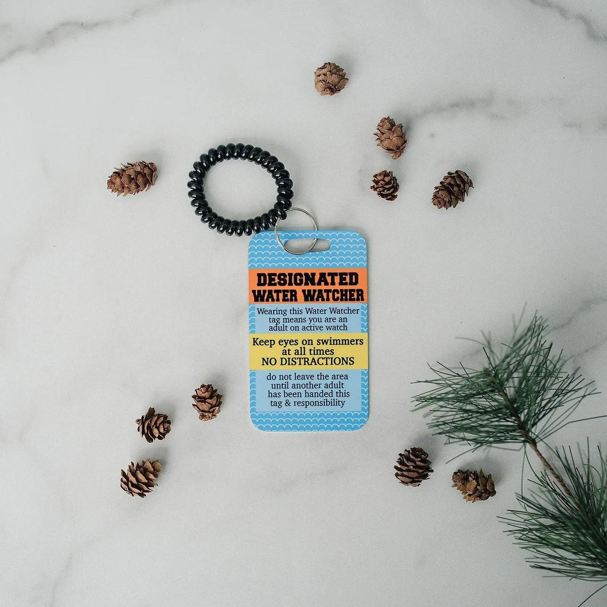 Pool safety badge tag with black beaded lanyard and blue card