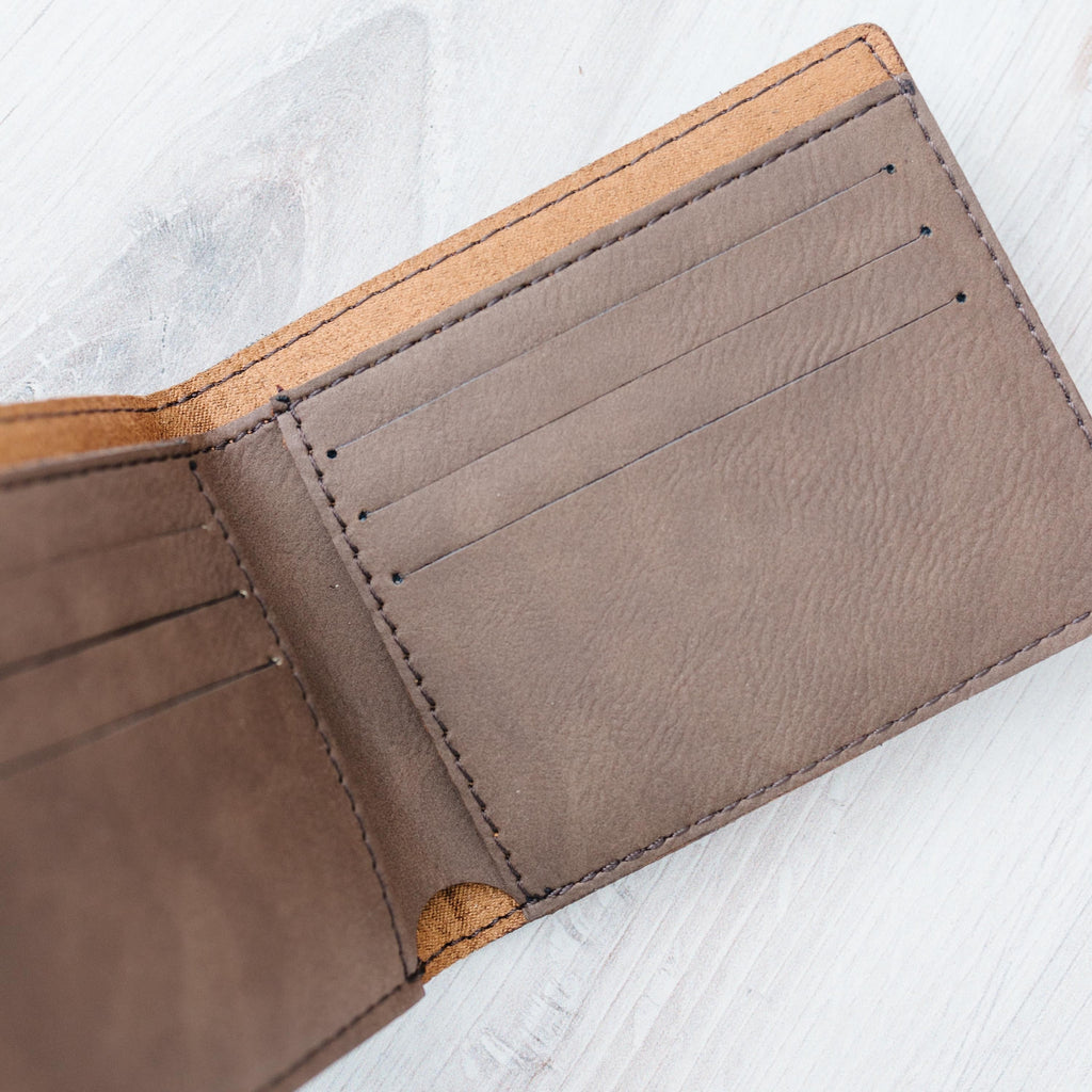 Brown leather slim bifold wallet interior with stitched card slots, top edge visible
