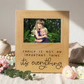 Natural wood photo frame with inner photo and 'Family is not an important thing' quote