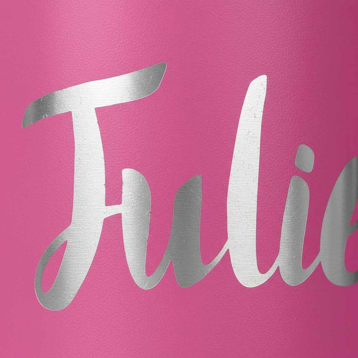 Pink tumbler close-up with white cursive lettering