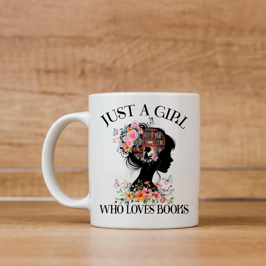 White ceramic coffee mug with floral silhouette and bookshelf design, “WHO LOVES BOOKS” text.
