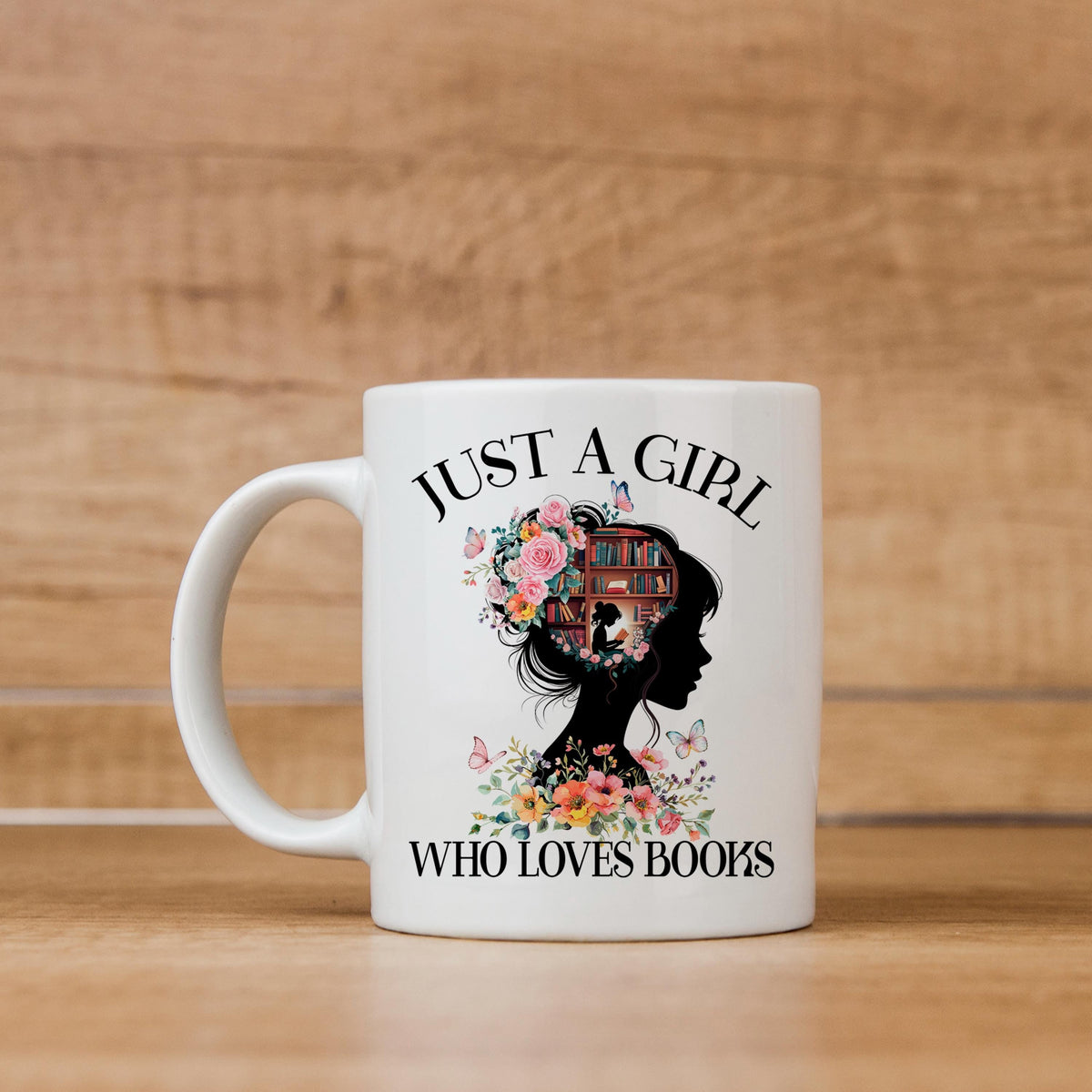 White ceramic coffee mug with floral silhouette and bookshelf design, “WHO LOVES BOOKS” text.