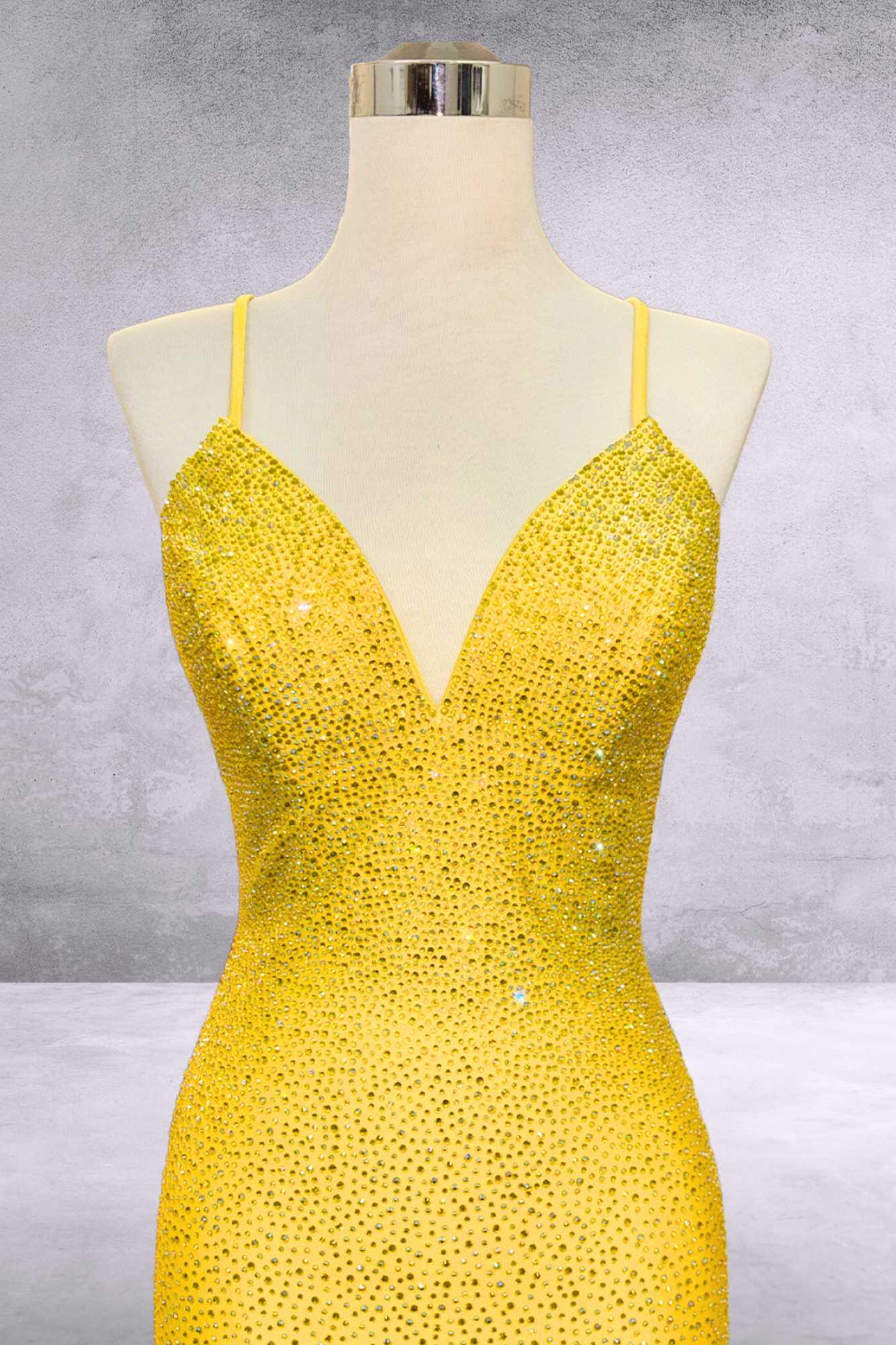 Sequined mermaid gown with deep V-neck and spaghetti straps in bright yellow